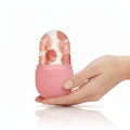 Close-up of pink silicone ice roller held in hands with condensation
