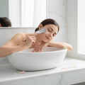 Woman using rose gold ultrasonic skin scrubber on cheek